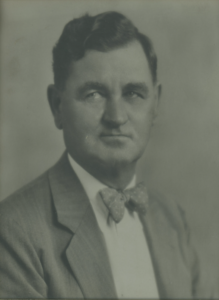 Black and white portrait of Henry W. Zipf with a bowtie and suite