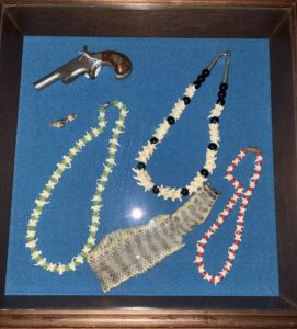 Catherine Reidy's pistol and necklaces made for Rattlesnake vertebrae