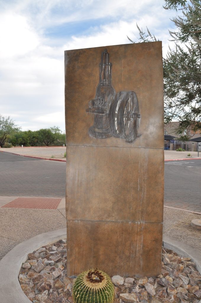 Column of Progress Bronze Fountain consists of three sculpture reliefs, a mountain range, a steer, and a steam pump