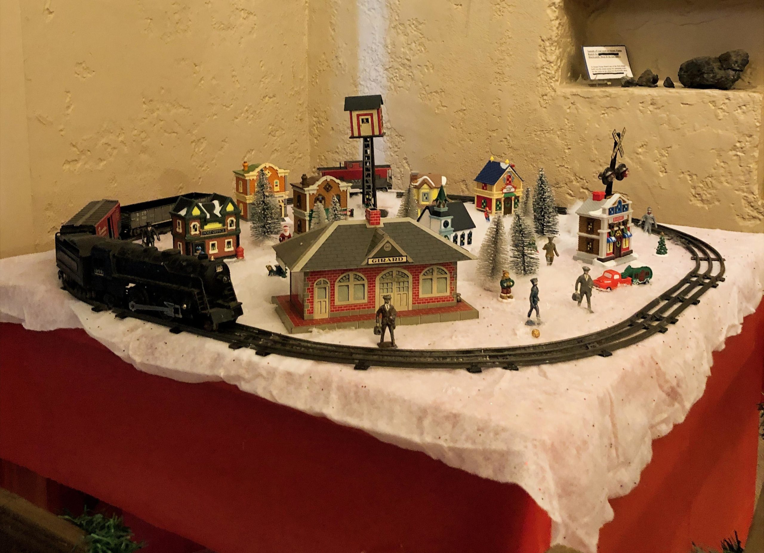 Circular train track on a table in a winter scene.