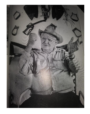 Buster Bailey Sitting in a Chair Wearing a Cowboy Hat