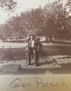 An Older George Pusch Sitting in Chair in Back Yard