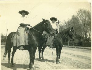 Gertrude Pusch "Tootsie" (on right) with Woman in Skirts and Long Gloves on Horses on Dirt Road