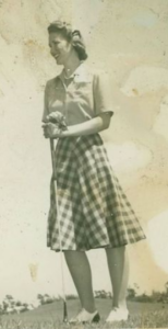 Black and white photo of Betty Procter-Leiber Golfing in a plaid skirt