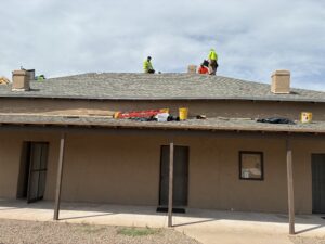 Roofers working on top of the Pusch House Museum - August 2026