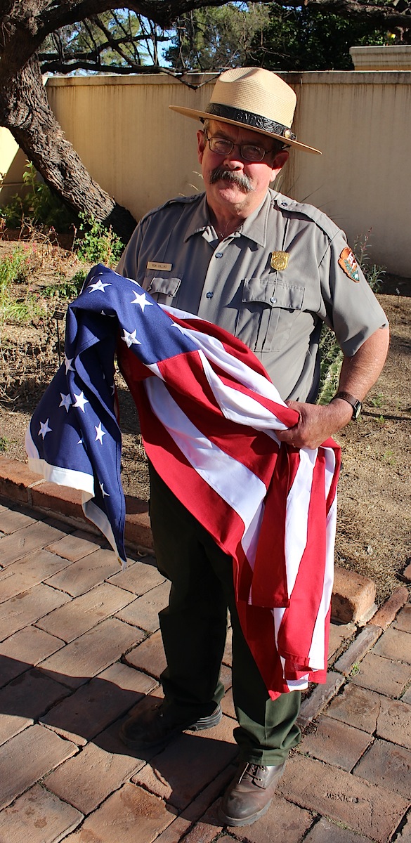 Rick Collins, Retired National Park Ranger in Uniform holding an American Flag