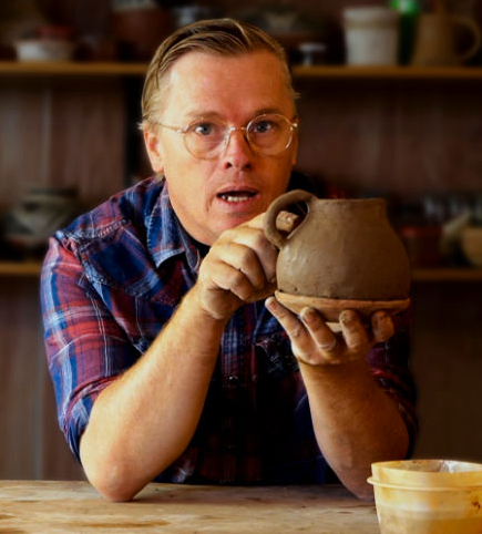 Man making a pot out of clay
