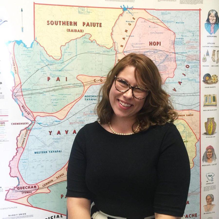 Jaynie Adams of Arizona Historical Society standing in front of a map